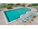 Aerial view of a refreshing community pool with ample lounging space, surrounded by lush landscaping at 700 Melrose Ave # L-23, Winter Park, FL 32789