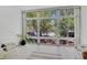 Bright sunroom featuring large windows with beautiful outdoor views and tile flooring at 700 Melrose Ave # L-23, Winter Park, FL 32789