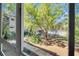 Picturesque window view of lush landscaping, trees, and a community pool, creating a tranquil backdrop at 700 Melrose Ave # L-23, Winter Park, FL 32789