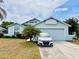 Charming single-Gathering home with a two-car garage, palm tree, and well-manicured front yard at 72 Saint Kitts Cir, Winter Haven, FL 33884