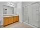 Bathroom features a double vanity, a large mirror, and a glass-enclosed shower at 7219 Rafanelli Ct, Orlando, FL 32818