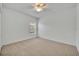 Bright, carpeted bedroom featuring a ceiling fan and a window with natural light at 7219 Rafanelli Ct, Orlando, FL 32818