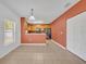 Dining area featuring tile floors, a view into the kitchen, and a storage closet at 7219 Rafanelli Ct, Orlando, FL 32818