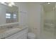 Bathroom featuring a granite vanity, mirror, and a tub-shower combination with tiled walls at 7717 Boreas Dr, Orlando, FL 32822