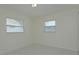 Neutral bedroom featuring tile flooring, two windows offering plenty of natural light at 7717 Boreas Dr, Orlando, FL 32822