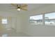 Serene bedroom with tile floors, a ceiling fan, and windows, providing ample natural light and ventilation at 7717 Boreas Dr, Orlando, FL 32822