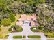 Aerial view showcasing a luxury home with beautiful landscaping, driveway, and architecture at 8713 Shimmering Pine Pl, Sanford, FL 32771