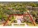 Wide aerial view of a luxury home on a large lot surrounded by trees, outlining property lines in red at 8713 Shimmering Pine Pl, Sanford, FL 32771