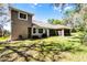 Enjoy the spacious backyard with lush grass and a well-maintained exterior with a tile roof and screened patio at 8713 Shimmering Pine Pl, Sanford, FL 32771