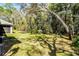 View of the lush backyard with mature trees, showcasing the property's private outdoor space at 8713 Shimmering Pine Pl, Sanford, FL 32771