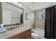 Bright bathroom featuring a large mirror, granite countertops and shower with tile surround at 8713 Shimmering Pine Pl, Sanford, FL 32771