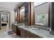 Bathroom featuring double sinks, granite countertops, and a large soaking tub at 8713 Shimmering Pine Pl, Sanford, FL 32771