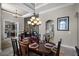 Elegant dining room featuring tray ceiling, chandelier, and access to office and kitchen at 8713 Shimmering Pine Pl, Sanford, FL 32771