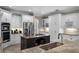 Kitchen with island and stainless steel appliances including a refrigerator and oven at 8713 Shimmering Pine Pl, Sanford, FL 32771