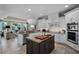 Open kitchen featuring a gray island, stainless steel appliances, and a view to the living room at 8713 Shimmering Pine Pl, Sanford, FL 32771