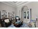 Cozy living room with a coffered ceiling, white columns, and a serene atmosphere at 8713 Shimmering Pine Pl, Sanford, FL 32771