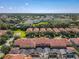 Expansive aerial view showcasing a large residential community with lush trees and scenic views at 8845 Candy Palm Rd, Kissimmee, FL 34747