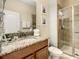 Bathroom featuring a granite countertop vanity and a glass-enclosed shower at 8845 Candy Palm Rd, Kissimmee, FL 34747