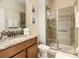 Bathroom featuring a granite countertop vanity and a glass-enclosed shower at 8845 Candy Palm Rd, Kissimmee, FL 34747