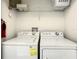 Clean, well-lit laundry room with modern side-by-side washer and dryer units at 8845 Candy Palm Rd, Kissimmee, FL 34747