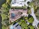 Aerial view of a luxury home with a private pool, tile roof, and meticulously maintained landscaping at 9372 Thurloe Pl, Orlando, FL 32827