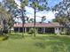 Expansive backyard featuring lush green lawn, mature trees, and a lovely view of the home at 9372 Thurloe Pl, Orlando, FL 32827