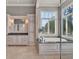 Elegant bathroom featuring dual vanities, a soaking tub, and a luxurious glass shower at 9372 Thurloe Pl, Orlando, FL 32827