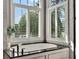 Close-up of a bathtub with granite countertop and white cabinets at 9372 Thurloe Pl, Orlando, FL 32827