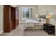 Warm and inviting bedroom featuring neutral carpet and a large window with plantation shutters at 9372 Thurloe Pl, Orlando, FL 32827