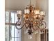 Close up view of the dining room's decorative wrought iron chandelier at 9372 Thurloe Pl, Orlando, FL 32827