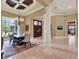 Formal dining room featuring tray ceiling, chandelier, and large windows at 9372 Thurloe Pl, Orlando, FL 32827