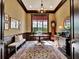 Elegant dining room featuring rich wood trim, a large window, and a decorative chandelier at 9372 Thurloe Pl, Orlando, FL 32827