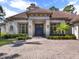 Stunning home featuring a tile roof, manicured landscaping, and a dark wooden front door at 9372 Thurloe Pl, Orlando, FL 32827