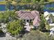 Stunning estate with a tile roof, lush landscaping, and a circular driveway nestled on a waterfront property at 9372 Thurloe Pl, Orlando, FL 32827