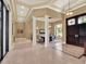 Elegant foyer with travertine floors, soaring ceilings, and an open floor plan at 9372 Thurloe Pl, Orlando, FL 32827