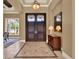 Grand foyer with a decorative tile floor, a tray ceiling, and an elegant chandelier at 9372 Thurloe Pl, Orlando, FL 32827