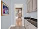 Hallway with view of bathroom vanities and beautiful tile floors at 9372 Thurloe Pl, Orlando, FL 32827