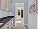 Hallway with view of adjacent rooms and beautiful tile floors at 9372 Thurloe Pl, Orlando, FL 32827