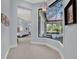 Hallway with bedroom entrance and view of the backyard pool through a geometric window at 9372 Thurloe Pl, Orlando, FL 32827