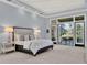 Bright main bedroom featuring a trey ceiling and french doors to the outdoor patio at 9372 Thurloe Pl, Orlando, FL 32827