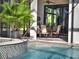 Poolside view of water feature and outdoor table/chairs at 9372 Thurloe Pl, Orlando, FL 32827