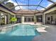 Inviting pool with a spa, screened enclosure, and lush tropical landscaping for outdoor enjoyment at 9372 Thurloe Pl, Orlando, FL 32827