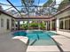 Gorgeous screened-in pool with a spa and lush landscaping for a private oasis at 9372 Thurloe Pl, Orlando, FL 32827