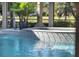 Inviting spa with a waterfall feature cascading into the sparkling pool at 9372 Thurloe Pl, Orlando, FL 32827