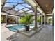 A luxurious pool and spa area featuring classic columns, beautiful tile work, and a serene atmosphere for relaxation at 9372 Thurloe Pl, Orlando, FL 32827