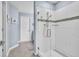 Modern bathroom with a glass-enclosed shower featuring white tiles and a mosaic accent stripe at 9401 La Salle St, Groveland, FL 34736