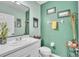 Stylish half-bath featuring modern fixtures, decor, and fresh green paint at 9401 La Salle St, Groveland, FL 34736