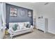 This bedroom features a textured blue accent wall, a large clock, and comfortable seating at 9401 La Salle St, Groveland, FL 34736