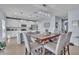 Dining area featuring a modern chandelier, a dining table with seating, and an open kitchen at 9401 La Salle St, Groveland, FL 34736