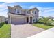 Beautiful two-story home with a brick driveway and well-manicured lawn at 9401 La Salle St, Groveland, FL 34736